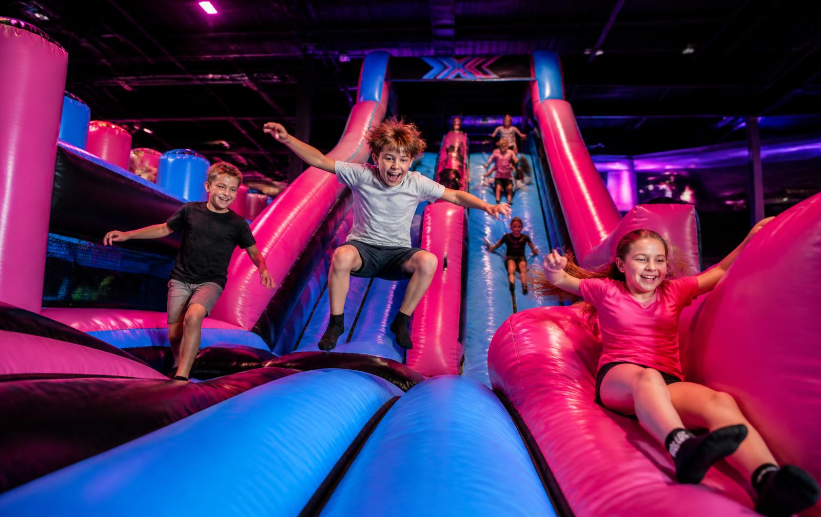 Kids jumping and sliding at Vertigo Fun Park